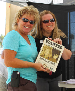 Lyn Demarat poses with Marquita McKnight and her Wanted poster at the Jail-A-Thon. Jillian Danielson/RiverScene 