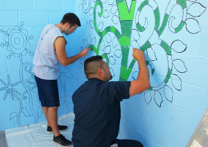 Steve Filmer and Ray Apalategui paint on a wall at HAVEN Saturday morning. 