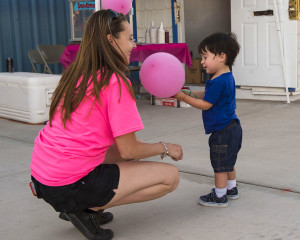 Cinco Schott, Age 2 receives a balloon from Heather Courneya. Heather is one of many volunteers and the organizer of the 6th annual “Denise’s Day” Fundraiser. Denise’s Day raises monies for Lake Havasu families impacted by Cancer. The event was held Saturday night at the rodeo grounds.  Mark Russell/RiverScene 