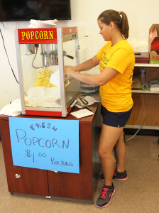 Maggie Schmeling bags popcorn Saturday morning at the Preschool Expo. Jillian Danielson/RiverScene 