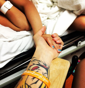 Zoey hold her mom's hand during a chemo treatment. 