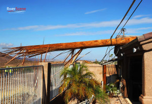 A telephone pole lies on a house after a microburst hit the southside of Lake Havasu on August 3, 2014. Jillian Danielson/RiverScene 