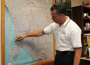 Lake Havasu Fire Department Chief Dennis Mueller draws on a map of Lake Havasu outlining flood plain areas. Jillian Danielson/RiverScene 