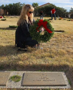 Stephanie Finch lays a wreath at the gravesite of a Veteran Monday morning. Jillian Danielson/RiverScene 