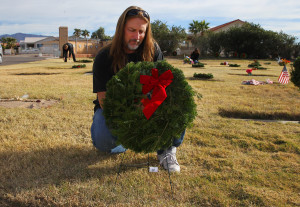 Dallas Finch lays a wreath at the gravesite of a Veteran Monday morning. Jillian Danielson/RiverScene 