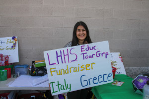 Carly Arevalo holds a sign in front of Big 5 while raising money for the LHHS Tour Group Monday afternoon. Rick Powell/RiverScene 