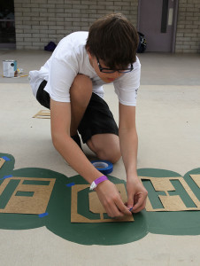 Jonathan Molien tapes letters to the ground Friday morning during Day of Service at Starline Elementary. Jillian Danielson/RiverScene 