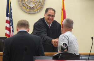 Judge Kalauli shakes the hand of every new veterans appearing before him. Judy Lacey/RiverScene 