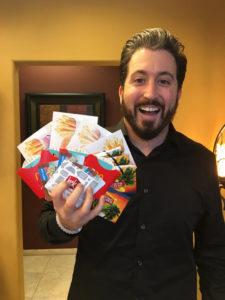 Dustin Runyon holds gift cards that he is donating to the event. 