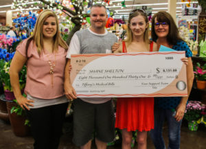 Ashley Lett, Shane, Tiffany and Erica Sheldon pose with a check that was donated for Tiffany's medical expenses. Rick Powell/RiverScene 