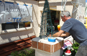David Jones sets up a Christmas decoration to welcome Tee home Thursday from the hospital. Jillian Danielson/RiverScene 