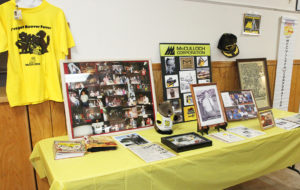 Photos and memorabilia sit on a table at the McCulloch Chainsaw reunion. Jillian Danielson/RiverScene 
