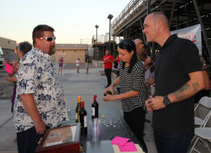 Levi French and Kimberly Carter volunteer for the Lake Havasu Cigars booth Tuesday evening. Jillian Danielson/RiverScene 