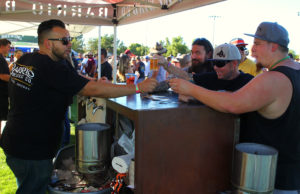 Beav Pruitt, Eric Hoff, and Dougie get some beer Saturday afternoon at Chillin and Swillin. Jillian Danielson/RiverScene 
