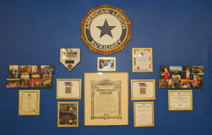 Auxiliary photos and plaques hang on the wall at the American Legion. Jillian Danielson/RiverScene 