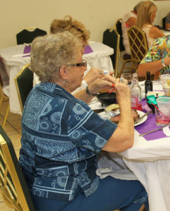 Penny Clark eats dinner at the Ladies Auxiliary celebration Monday evening. Jillian Danielson/RiverScene 