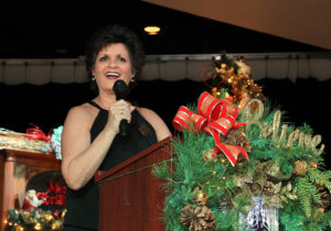 Connie Alexander speaks at the Christmas Tree Raffle Sunday afternoon. Jillian Danielson/RiverScene 