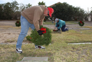 Paul Roe Sr. places a wreath on a Veteran's grave site Wednesday morning at Havasu Memorial Gardens. Jillian Danielson/RiverScene 