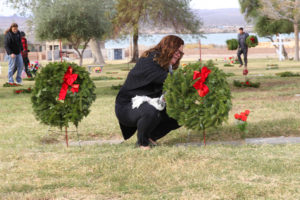 Kristina Gallo places a wreath on a Veteran's grave site Wednesday morning at Havasu Memorial Gardens. Jillian Danielson/RiverScene 