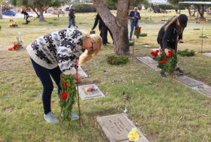 Suzanne Mike and Stephanie Finch place a wreath on a Veteran's grave site Wednesday morning at Havasu Memorial Gardens. Jillian Danielson/RiverScene 