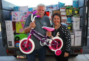 Bill Rozhon and Shelly Keirns pose with toys they donated Tuesday afternoon. Jillian Danielson/RiverScene 