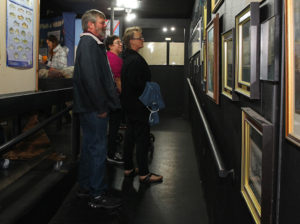 Gary and Eynon Petter, Onterio, Canada, and Sylvia Woodall, Coeur d' Alene Idaho, look at photos on a wall at the Visitors Center Wednesday afternoon. Jillian Danielson/RiverScene 