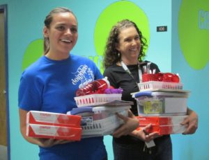From left, Nautilus Elementary teachers Sarah Didion and Leah Branch react after HYAC presented their care packages. 