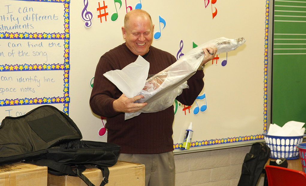 Only Orchids Makes Guitar Donation To Elementary Music Program