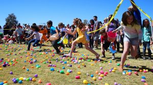 Children collect plastic eggs at the Sunrise Rotary Easter Egg Hunt Sunday. Jillian Danielson/RiverScen