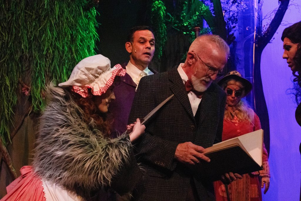 Samantha Reed as Little Red Riding Hood and Jim McCabe as the Narratorn (front) in Into the Woods